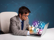 Handsome man sitting at desk and typing on laptop with 3d number