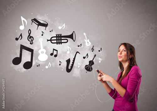 Photo: Beautiful young woman singing and listening to music with musica Beautiful young woman singing and listening to music with musica