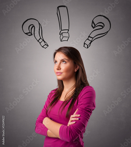 Photo: Young lady thinking with question marks overhead Young lady thinking with question marks overhead