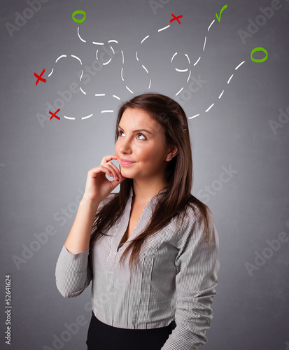 Photo: Young woman thinking with abstract marks overhead Young woman thinking with abstract marks overhead
