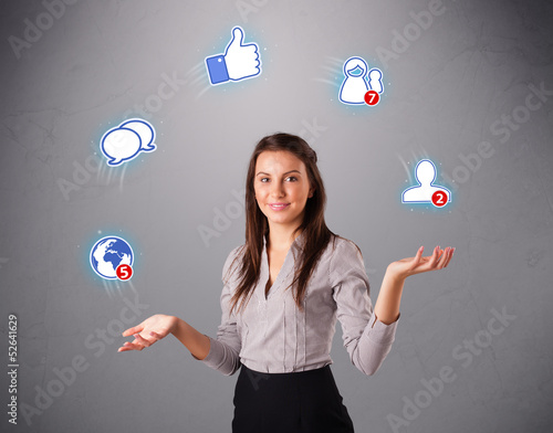 Photo: attractive young woman juggling with social network icons attractive young woman juggling with social network icons