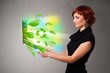 Casual woman holding notebook with recycle and environmental sym