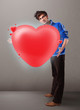 Young man holding lovely 3d red heart