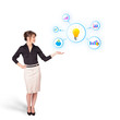 Photo: Young woman presenting light bulb with colorful graphs and diagr Young woman presenting light bulb with colorful graphs and diagr