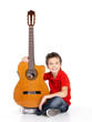 happy  boy is playing on acoustic guitar