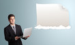 handsome man holding a laptop and presenting modern copy space o