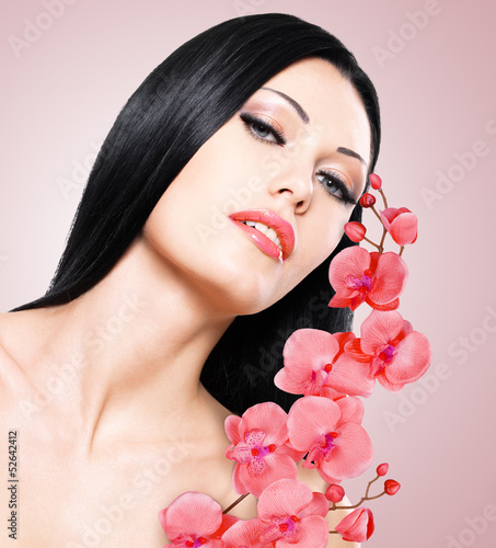 Photo: woman with beautiful face and fresh flowers woman with beautiful face and fresh flowers