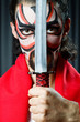 Man with sword and face mask