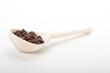 wooden spoon with coffee beans, isolated on white