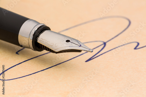 Photo: signature and pen signature and pen