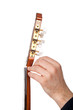 Person tuning a guitar from its headstock over white background