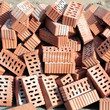Heap of red ceramic hollow bricks