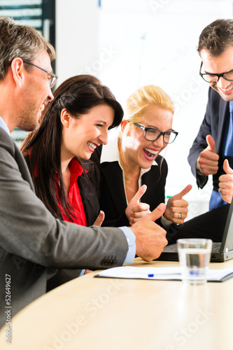 Photo: Business people looking at laptop with success Business people looking at laptop with success