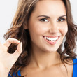 Young woman showing okay gesture, over grey