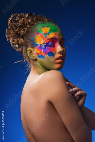 Photo: Portrait girl with fashionable make-up and flowers Portrait girl with fashionable make-up and flowers