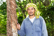 Asian man cutting rubber tree