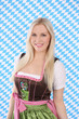 Junge Frau im Dirndl vor Rautenmuster