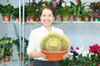 woman in flower shop with cactus