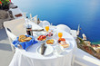 Breakfast on a terrace overlooking the sea in Oia