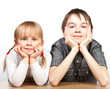 Foto: Sister and brother sitting at desk Sister and brother sitting at desk