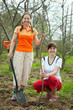 Happy women planting fruit tree