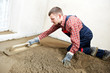 Photo: Plasterer concrete worker at floor work Plasterer concrete worker at floor work