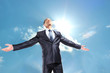 Happy businessman standing outside with arms outstretched