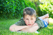 Photo: boy with a book on the grass boy with a book on the grass
