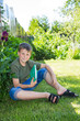 Photo: boy with a book on the grass boy with a book on the grass
