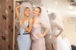 Two girlfriends Having fun in bridal Boutique