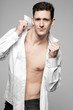 Photo: Handsome man in white shirt on gray. Handsome man in white shirt on gray.