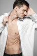 Photo: Handsome man in white shirt on gray. Handsome man in white shirt on gray.