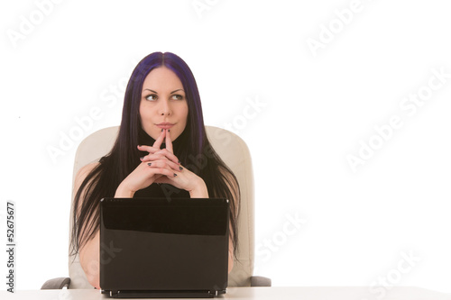 Photo: Contemplating business woman behind notebook Contemplating business woman behind notebook