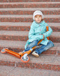 Girl with blue cloak with scooter