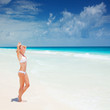 Cute female suntanning on seashore