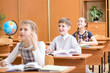 school children at lesson in classroom