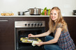  woman cooking saltwater fish  in oven at  kitchen