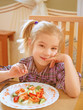 smiling girl eating salad