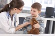Veterinary and kid discussing rabbit treatment