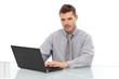 Photo: Young man using laptop Young man using laptop