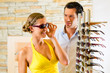 Photo: Young couple at optician with glasses Young couple at optician with glasses