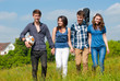 Photo: Four happy teenage friends walking together outdoors Four happy teenage friends walking together outdoors