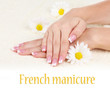 Woman hands with french manicure and flowers on towel