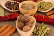 Nutmeg and other spices on sackcloth background