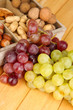 Grape With Nuts On Wooden Table