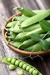 Green peas on a wooden background