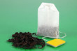 Tea bag on green background