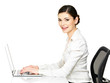 woman sits from the  table and working on laptop