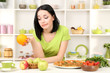Pretty girl selects pizza or diet on kitchen background
