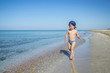 Cute child boy is running in sea